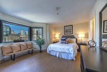 A bedroom with a bed and a large window